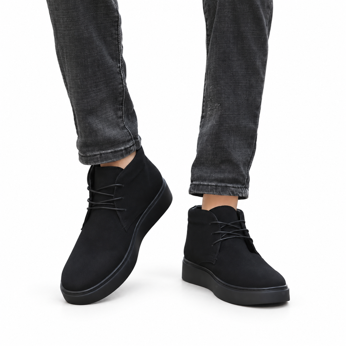 AI-assisted white-background styling edit of the original Amali Zale black chukka boots on-foot photo with dark jeans; refer to original product photos for details.
