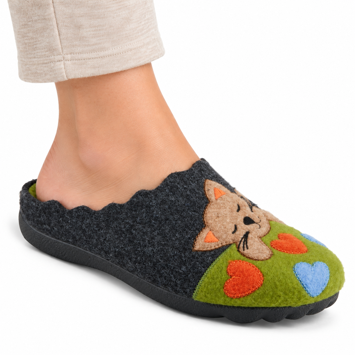 AI-generated on-model styling illustration of the Flexus Cuttlecat Green/Multi slipper with cat and heart appliques, worn on a white studio background.