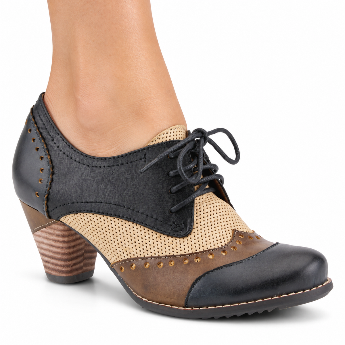 AI-generated image of an adult woman wearing the L'Artiste Bardot lace-up heeled shoe in Navy, with dark panels, taupe-brown trim, a beige perforated insert and a brown block heel, on a white background.
