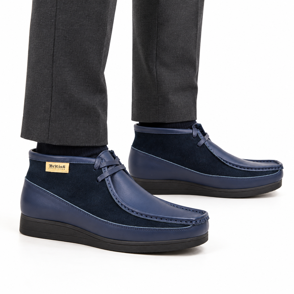 AI-generated on-model view of British Walkers New Castle Classic navy blue leather-and-suede ankle boots with charcoal trousers on a white background.