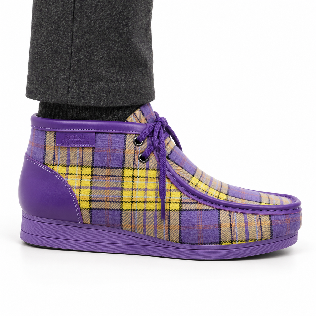 AI-generated styling view of a British Walkers New Castle Purple Plaid ankle boot worn with charcoal trousers on a white background.