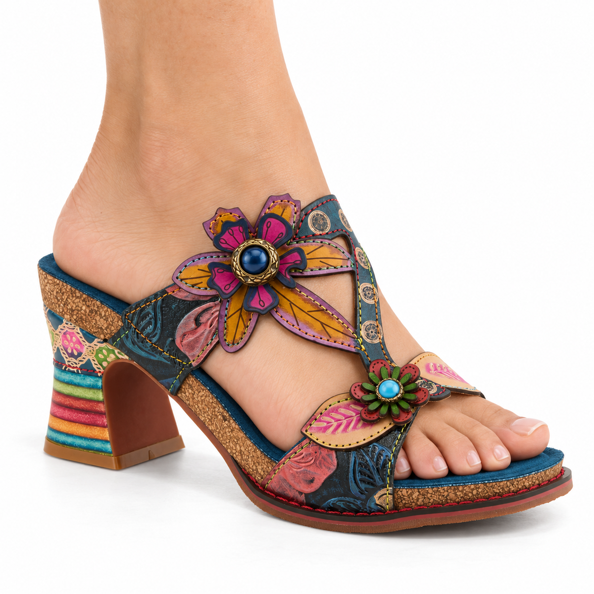 AI-generated on-model view of the L'Artiste Rossie sandal in Navy Multi, with multicolored floral appliques and a striped sculpted heel, on a white background.