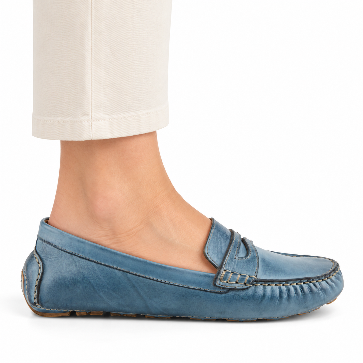 Spring Step Audette penny loafer in Blue, side view on foot against white; AI-generated styling illustration