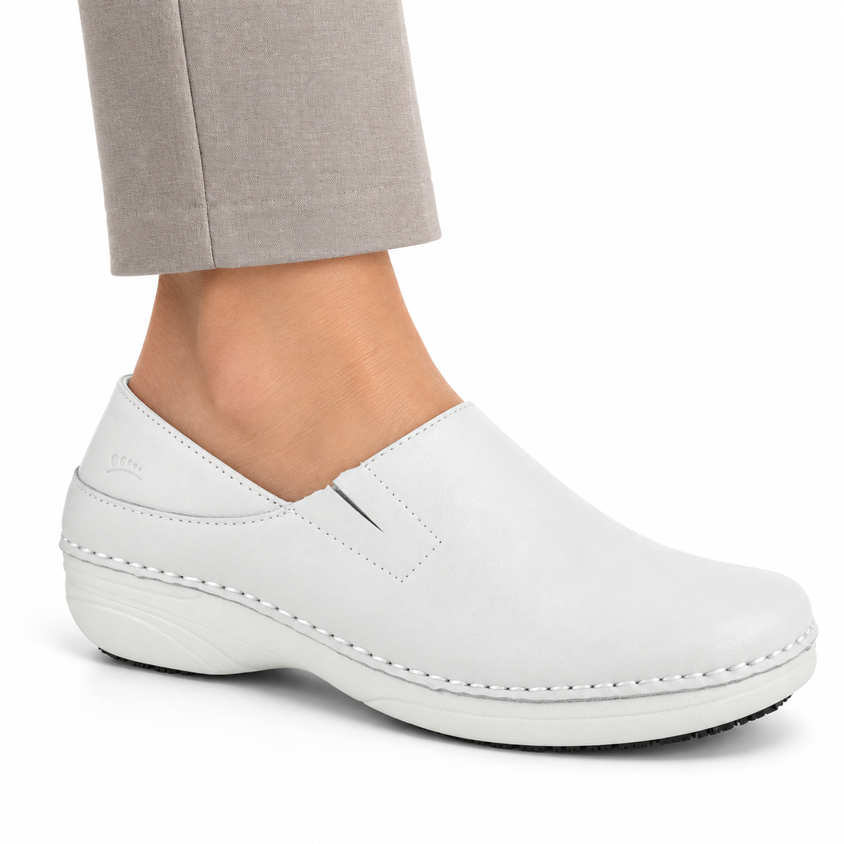 AI-generated styling view of a white Spring Step Professional Manila slip-on, worn with taupe trousers on a white studio background.