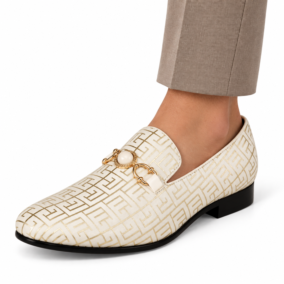AI-generated styling illustration of an Amali Kazimar cream and gold geometric-pattern loafer worn with taupe trousers on a white background; fine pattern and ornament details are illustrative, refer to original product photos.