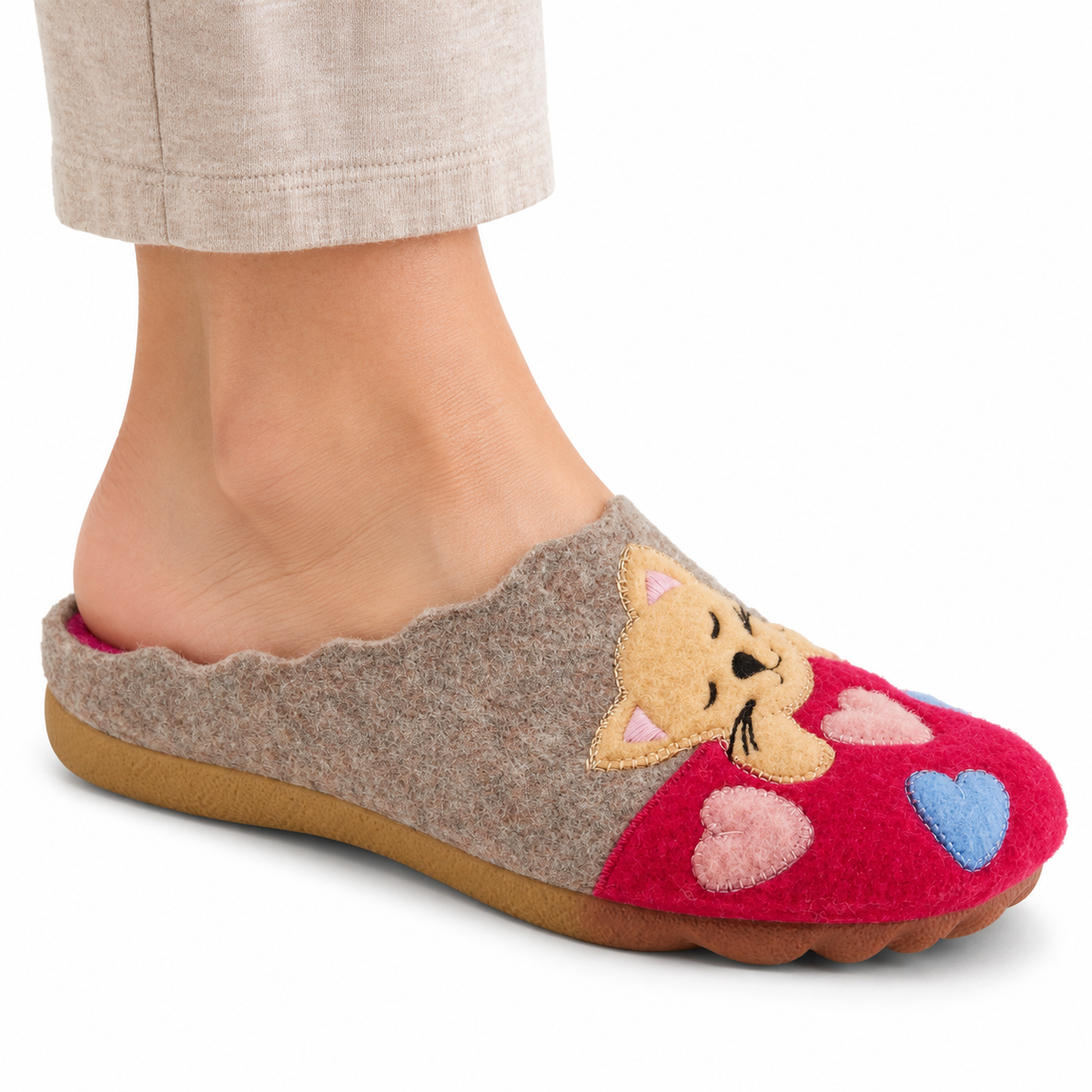 AI-generated on-model styling illustration of the Flexus Cuttlecat Fuchsia/Multi slipper with cat and heart appliques, worn on a white studio background.