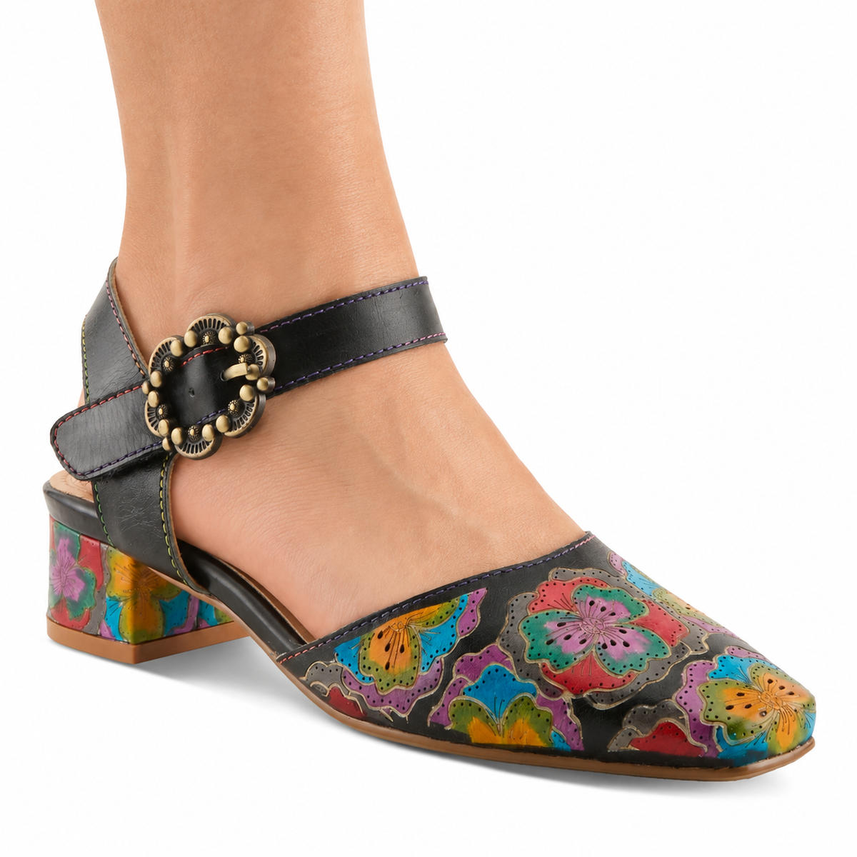 AI-generated model view of the L'Artiste Funferbiz Black Multi closed-toe slingback shoe, with colorful floral leather, a low block heel and an antique-brass buckle, on white.