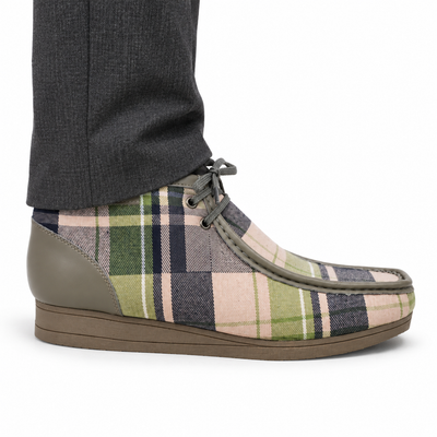 AI-generated on-model styling view of a British Walkers New Castle Limited Plaid Gray Multi Plaid ankle boot, worn with charcoal trousers on a white studio background.