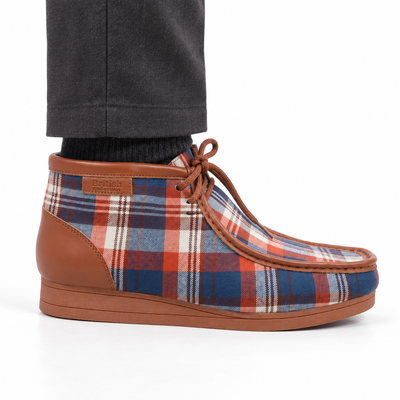 AI-generated styling view of a British Walkers New Castle Brown Plaid ankle boot worn with charcoal trousers on a white background.