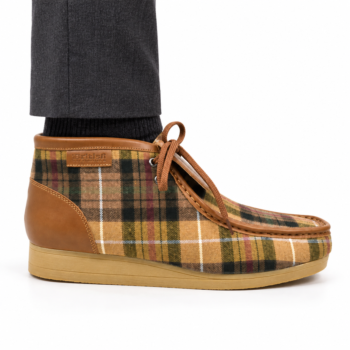 AI-generated styling view of a British Walkers New Castle Tan Plaid ankle boot worn with charcoal trousers on a white background.