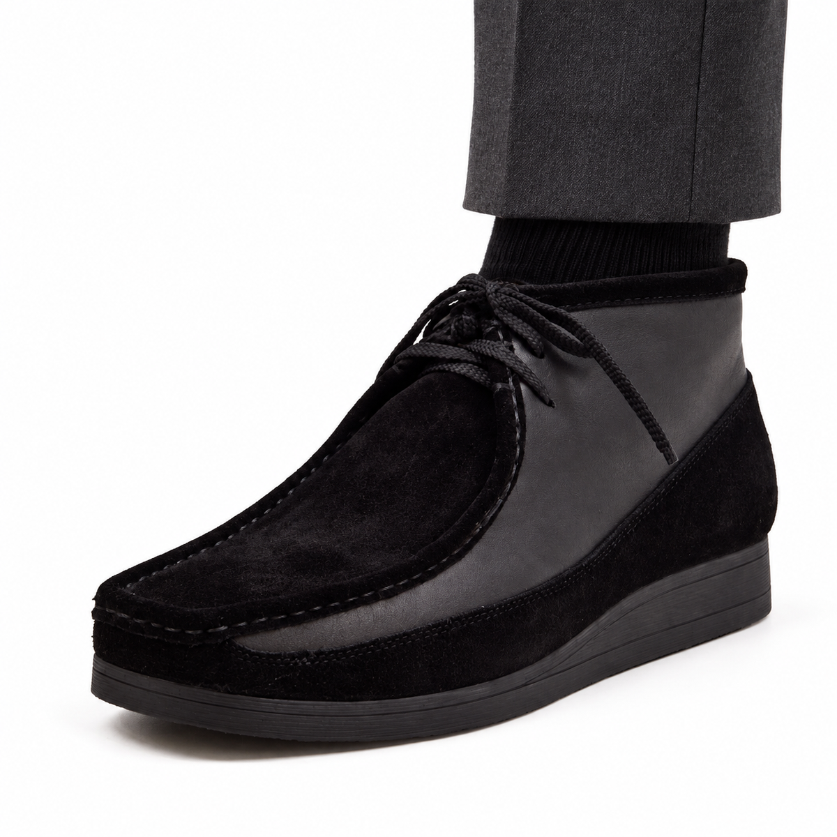 AI-generated on-model styling view of British Walkers New Castle Black suede and leather ankle boot, worn with charcoal trousers on a white studio background.