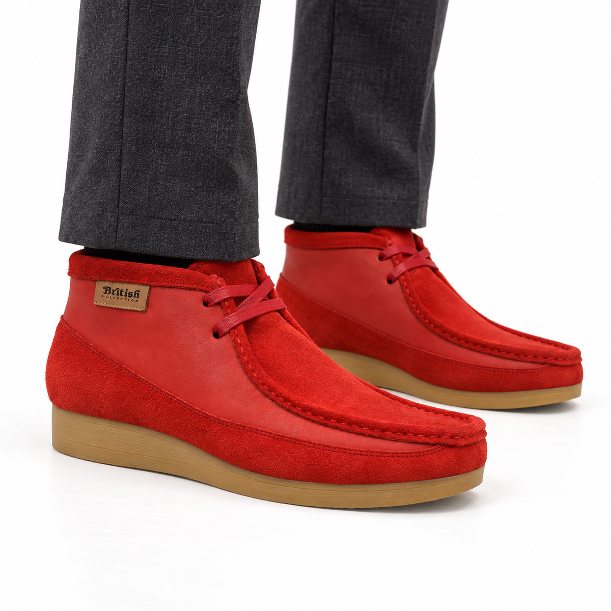 AI-generated on-model styling view of British Walkers New Castle Red suede and leather ankle boots, worn with charcoal trousers on a white studio background.