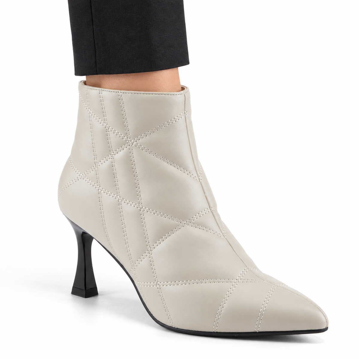 AI-generated on-model styling illustration of the Patrizia Theana off-white ankle boot with irregular geometric stitching, a pointed toe, thin black sole and sculpted black heel, worn with dark trousers against a white studio background. Styling is illustrative; consult the original product photos for exact details.