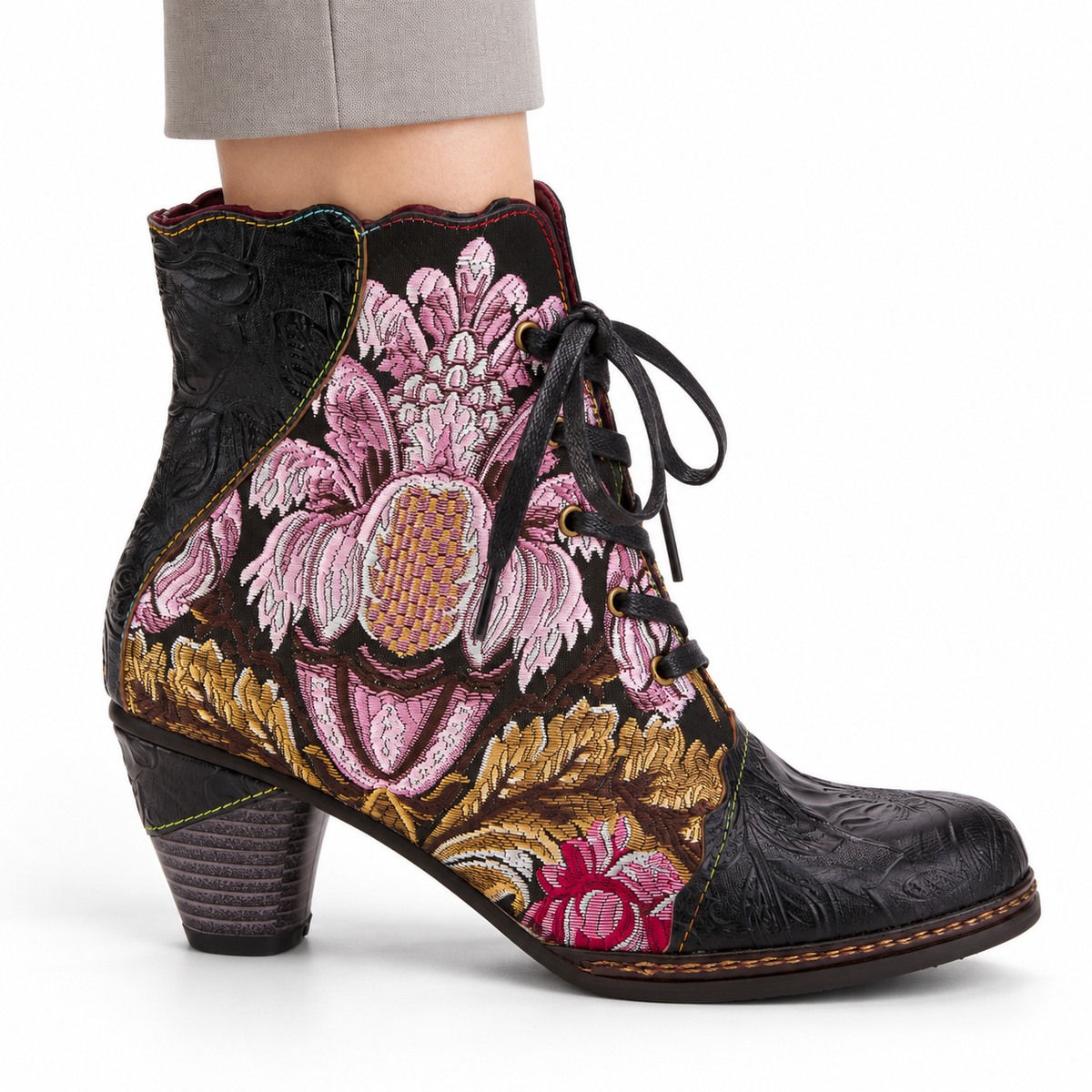 AI-generated styling view of L'Artiste Siren women's Black / Multi floral lace-up ankle boot, outer side on a model against white.