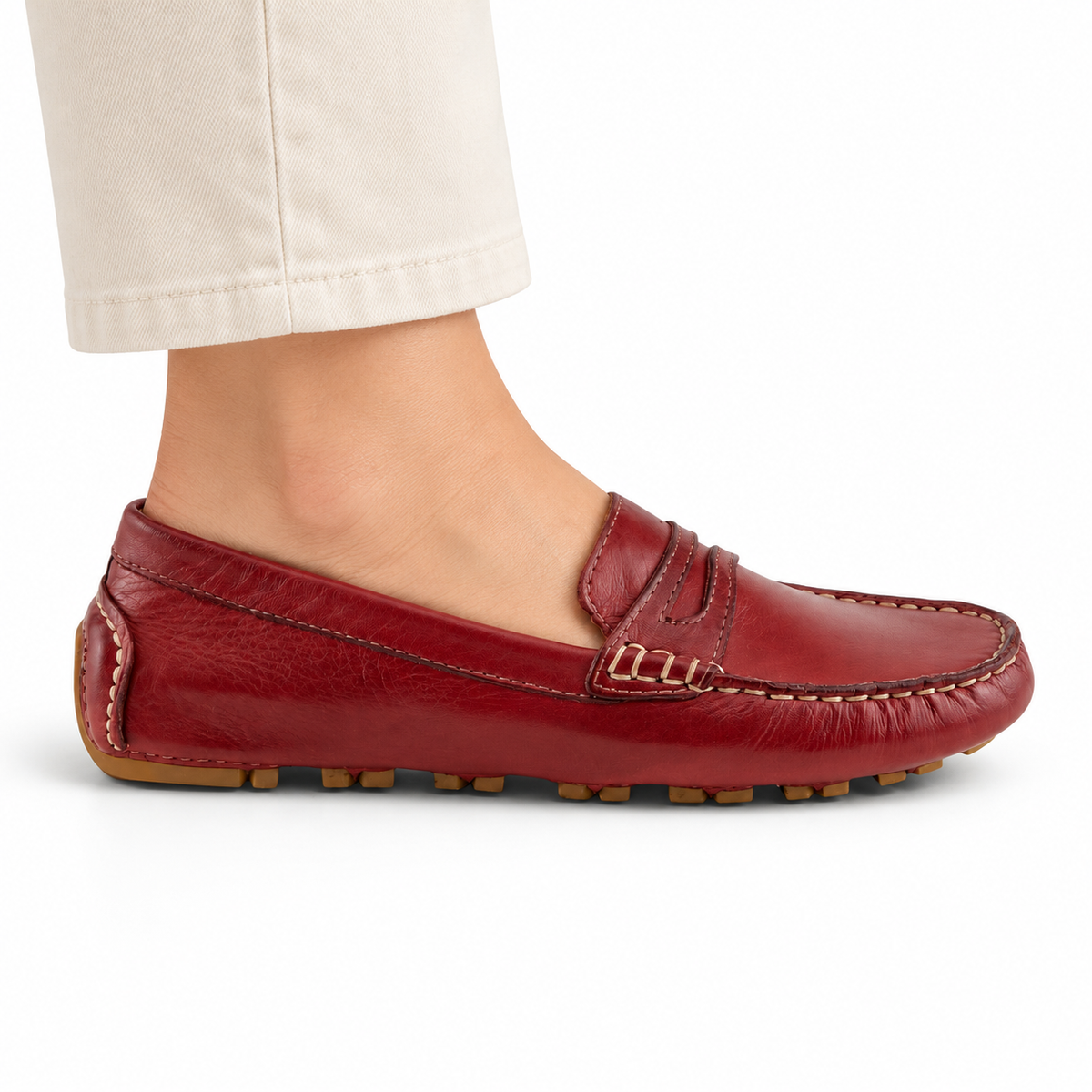 Spring Step Audette penny loafer in DARK RED, side view on foot against white; AI-generated styling illustration