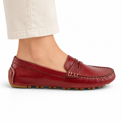 Spring Step Audette penny loafer in DARK RED, side view on foot against white; AI-generated styling illustration