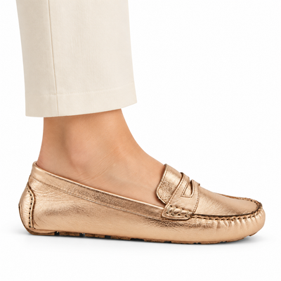 Spring Step Audette penny loafer in Rose Gold, side view on foot against white; AI-generated styling illustration