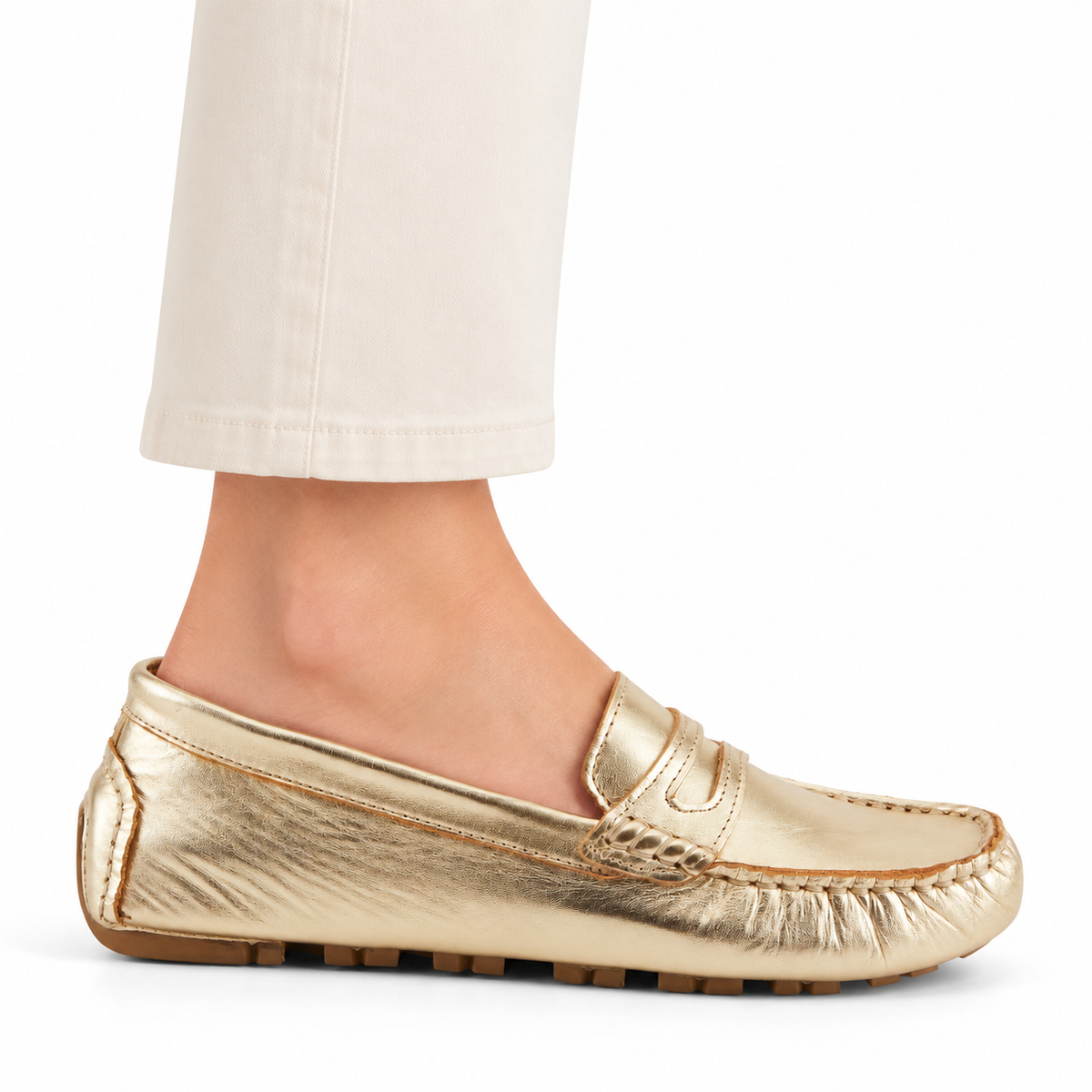 Spring Step Audette penny loafer in Soft Gold, side view on foot against white; AI-generated styling illustration