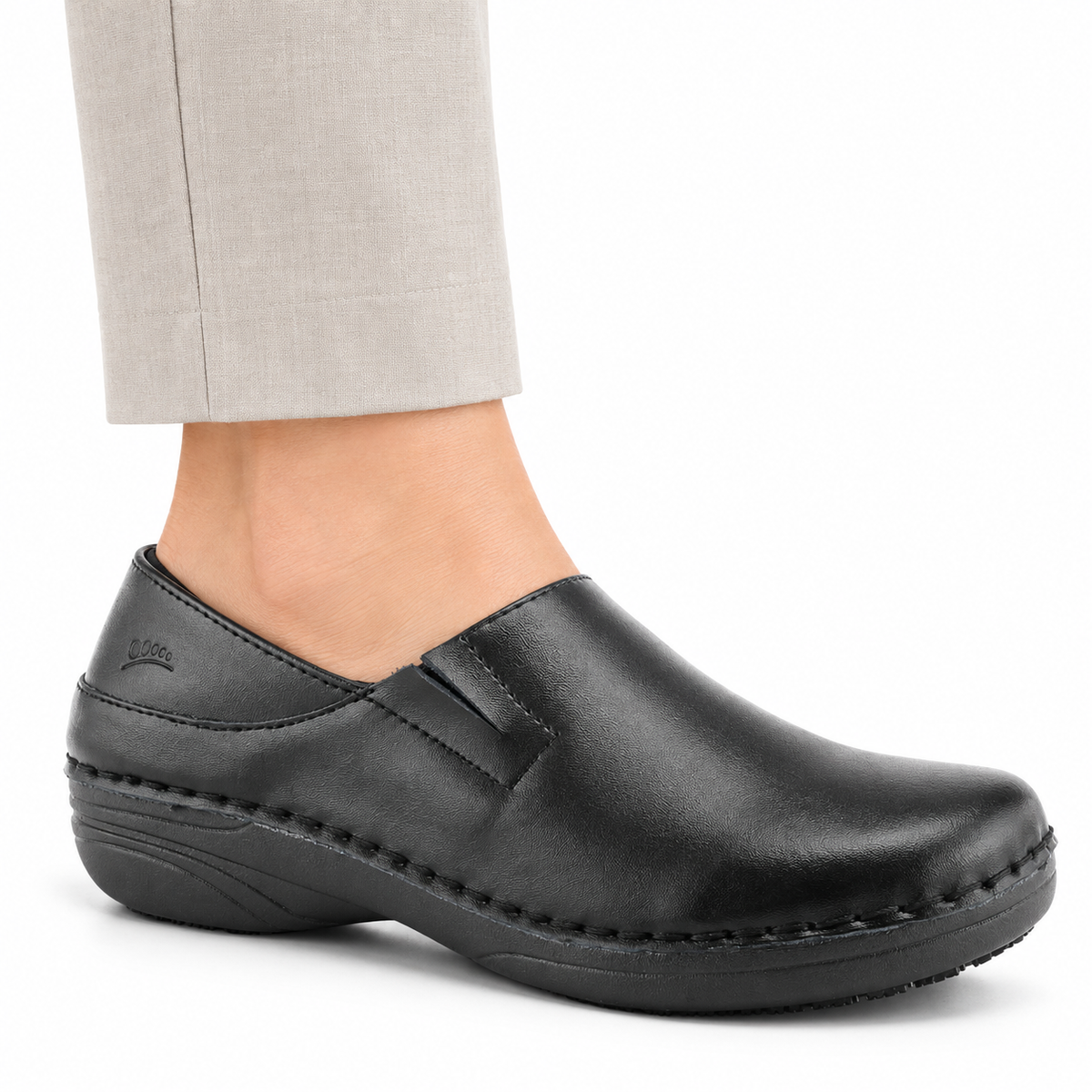 AI-generated on-model view of the black Spring Step Professional Manila slip-on shoe with neutral trousers on a white studio background.