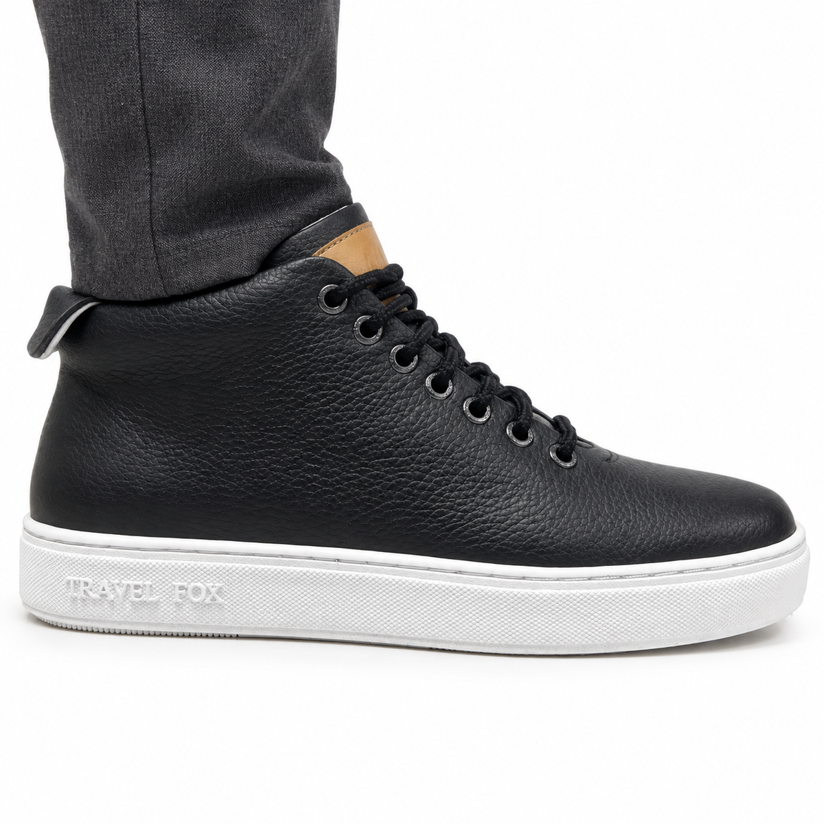 AI-generated on-model styling view of a Travel Fox Black 915612 101 mid-top shoe, worn with charcoal trousers on a white studio background.