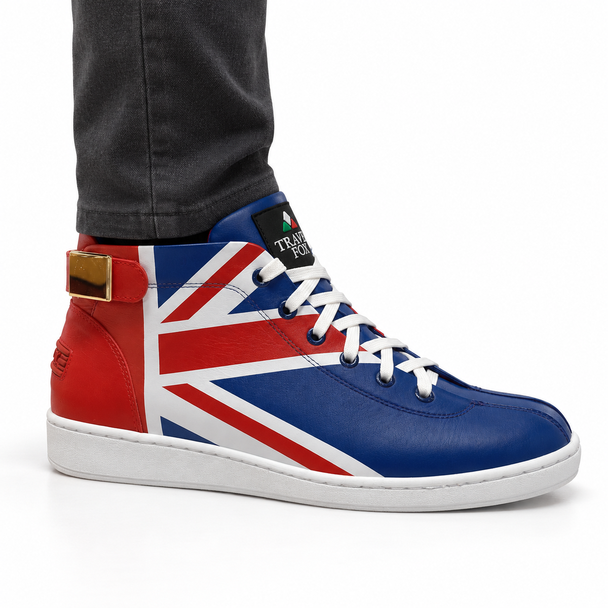 AI-generated on-model styling view of a Travel Fox Union Jack 915601-21 red, white and blue mid-top shoe, worn with charcoal trousers on a white studio background.